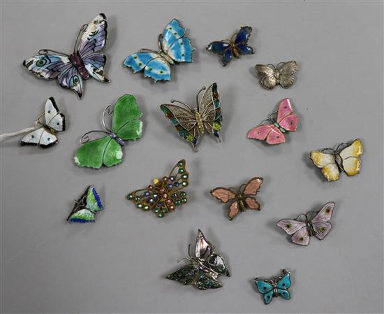 Fourteen assorted butterfly brooches including silver and enamel and filligree and a butterfly earclip.